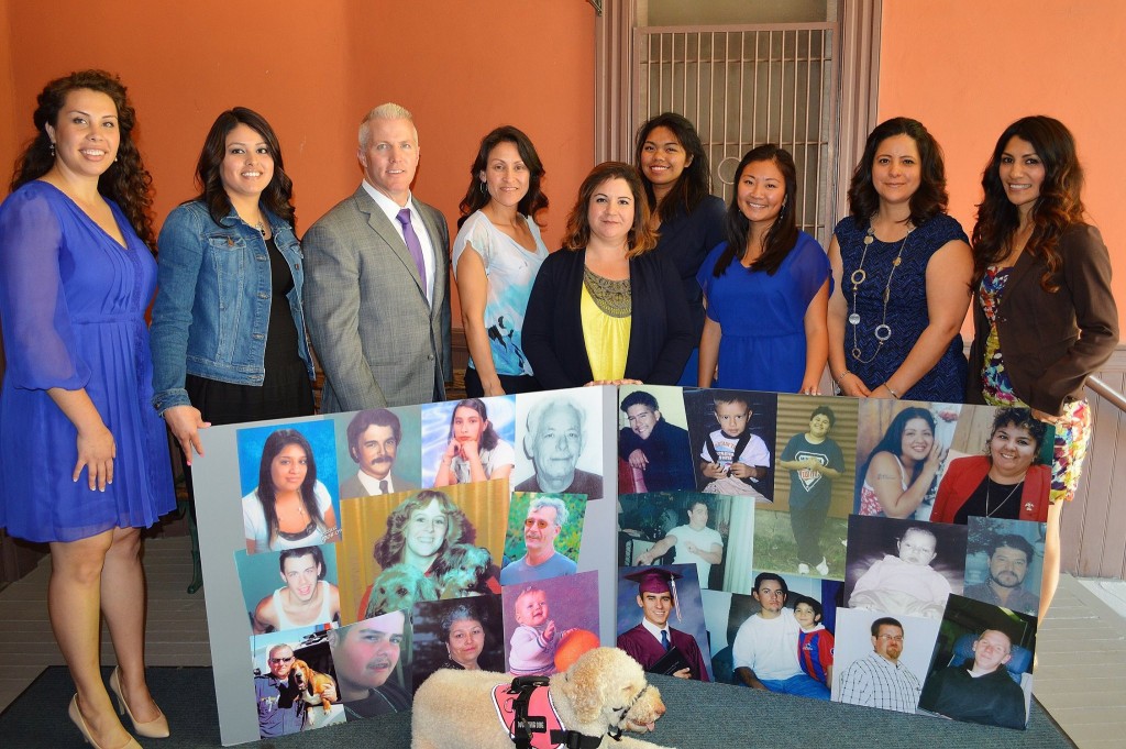 District Attorney Reisig with Victim Services Program representatives and photos of deceased crime victims