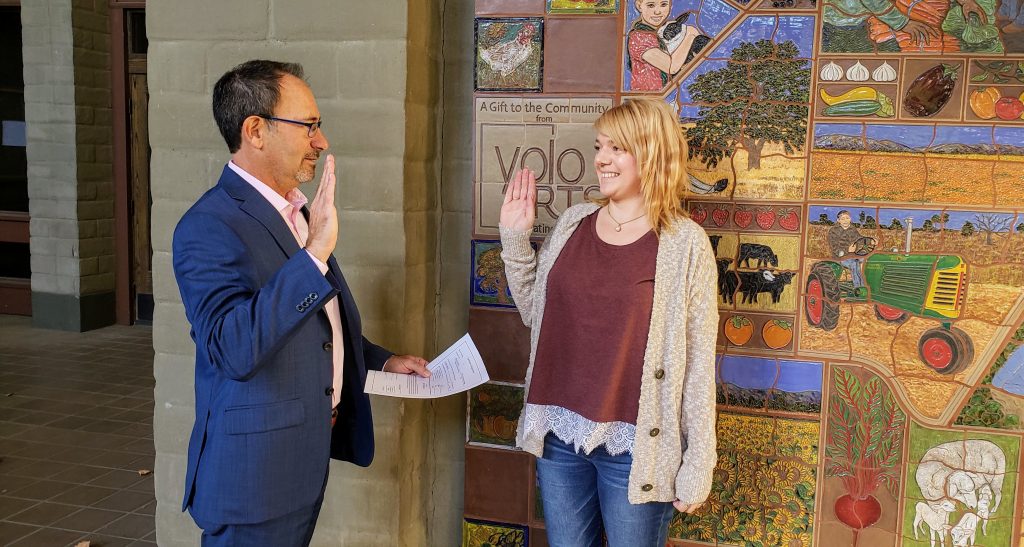 The image includes Jessie Tessler being sworn in by Jonathan Raven.