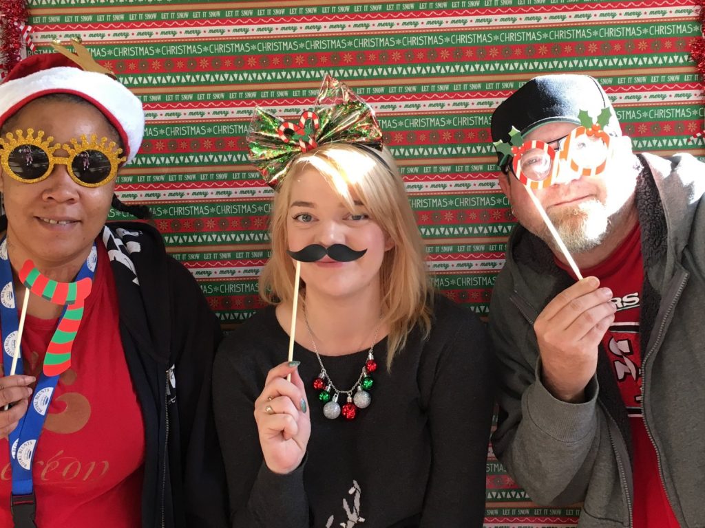 Image depicts previous Mental Health Court participants having fun at the photo booth.