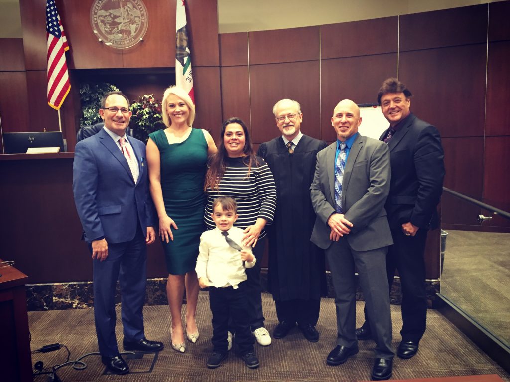 Image includes the addiction intervention court graduate along with her son and the AIC team.