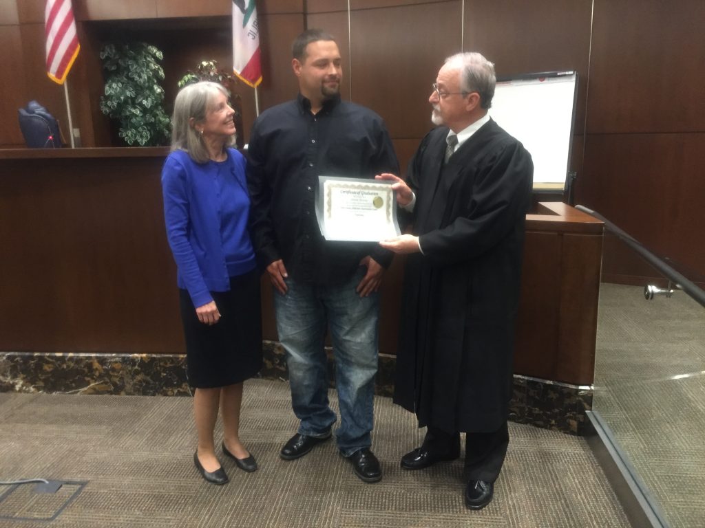 Image depicts AIC graduate Steven Alcaraz with Ret. Judge Gaard and Judge Rosenberg