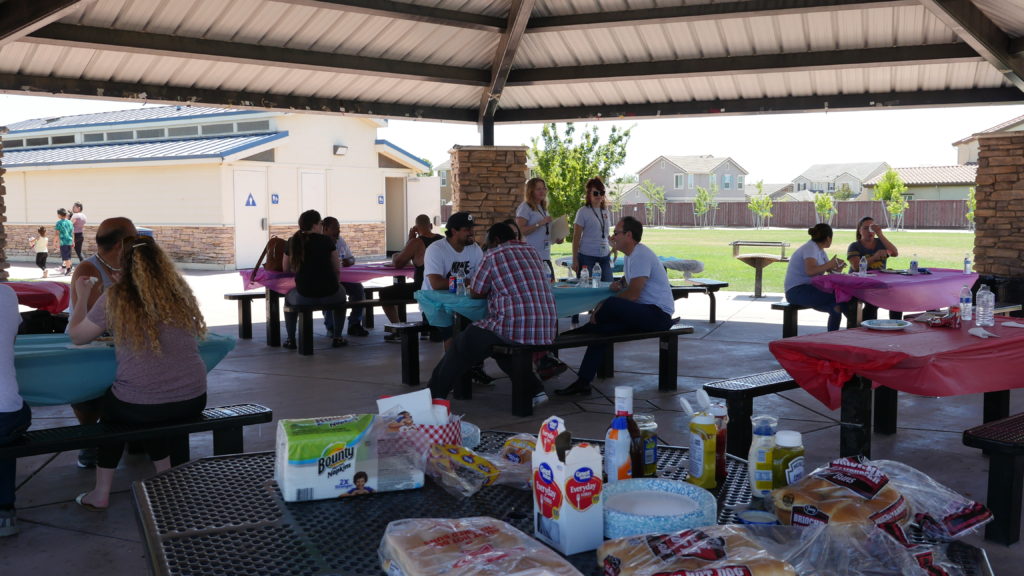 Image depicts the food table and MHC graduates dining with MHC staff.
