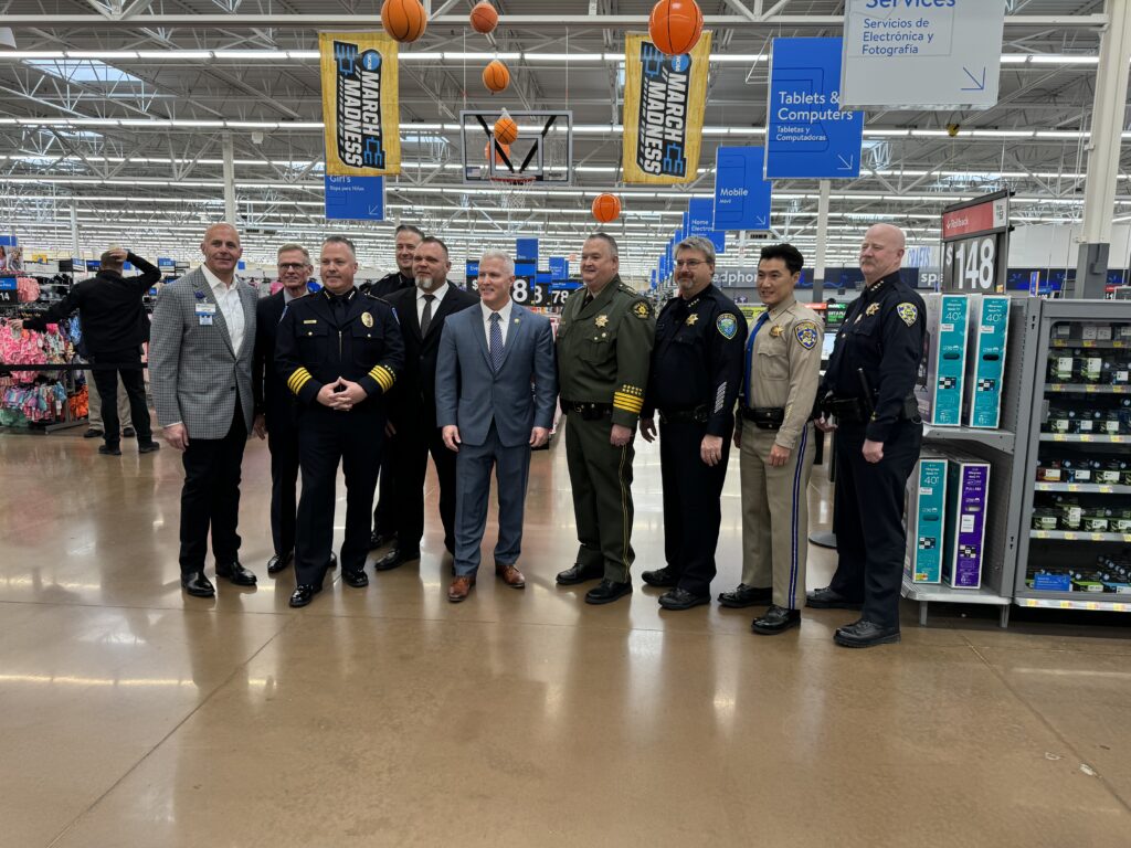 Image depicts DA Jeff Reisig along with all Yolo County law enforcement leaders and Walmart loss prevention executives at press conference.