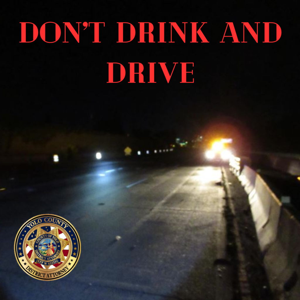 Image depicts the words don't drink and drive with emergency lights in the background.